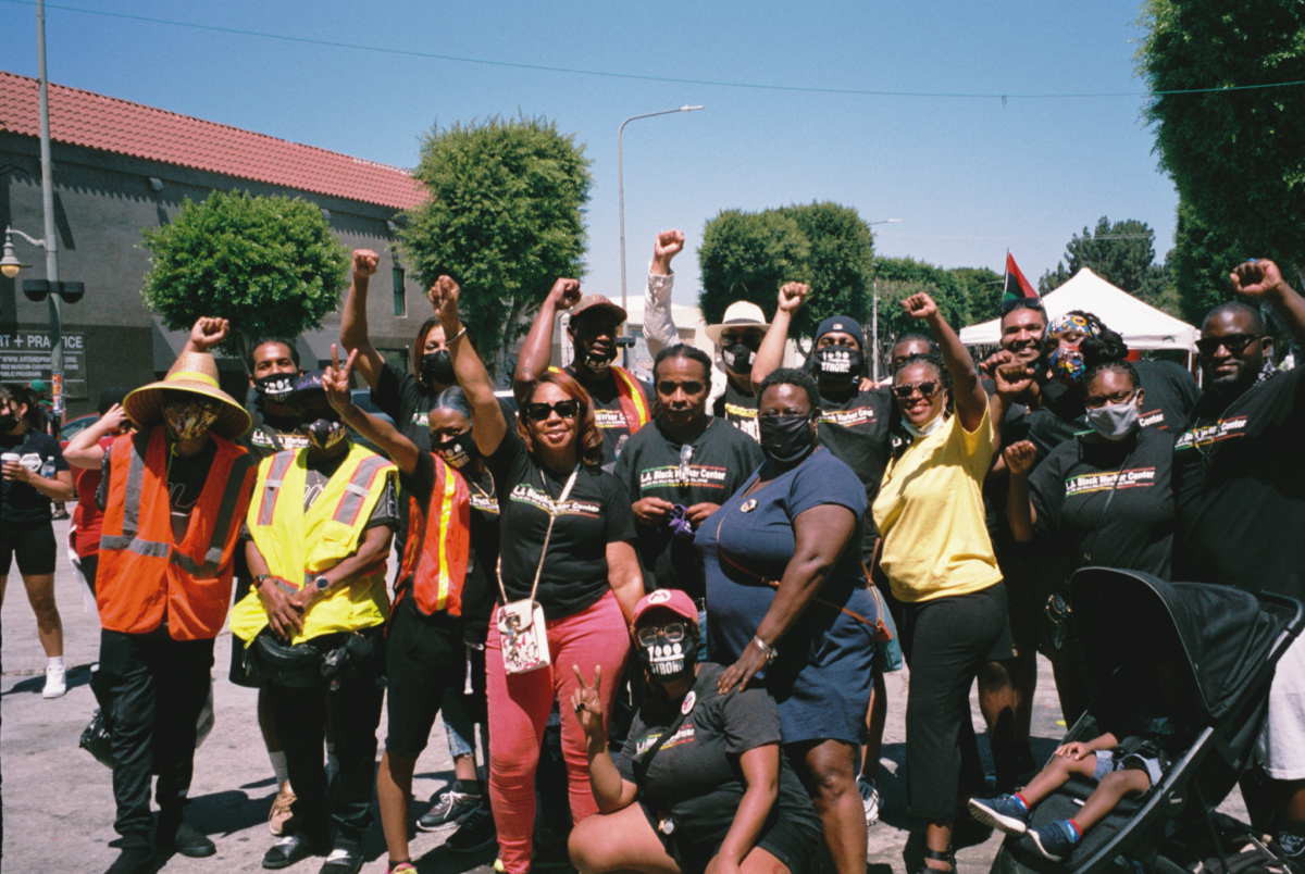 Photo of a group of people posing with their fists in the air