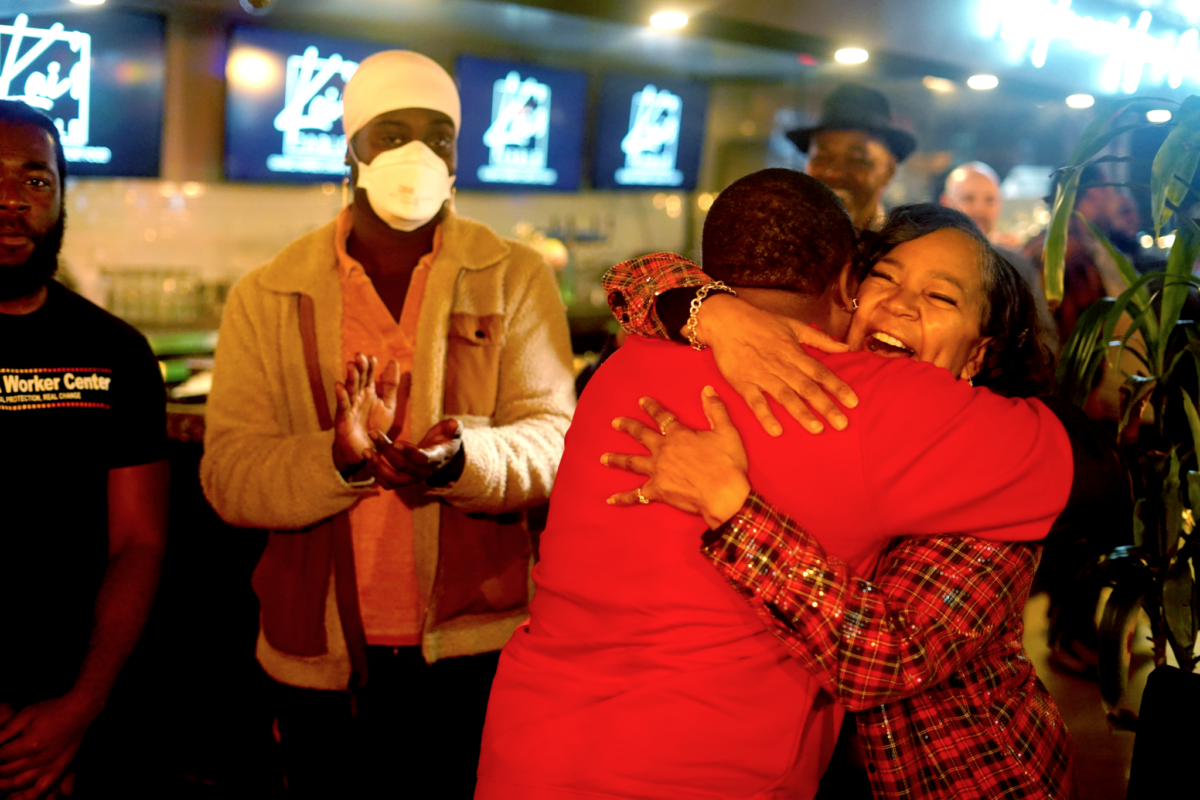 Photo of two people hugging and laughing